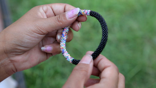 Handmade glass bead bracelet from Nepal, featuring a roll design. Also known as a beaded bracelet, seed bead bracelet, beach glass bracelet, or sea glass bracelet.